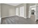Living room features gray laminate flooring, two closets and an open kitchen at 3302 Dogwood Dr # 123, Atlanta, GA 30354