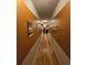 Long hallway featuring wood floors and earth tone colored walls at 7848 Rock Rose Ln, Fairburn, GA 30213