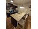 Eat-in kitchen featuring a large island with seating and modern lighting at 7848 Rock Rose Ln, Fairburn, GA 30213
