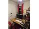 Home office with a desk, ergonomic chair, a monitor, and a window with red curtains at 7848 Rock Rose Ln, Fairburn, GA 30213