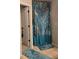 Shower with designer blue curtain in bathroom with tile flooring and matching blue rugs at 7848 Rock Rose Ln, Fairburn, GA 30213