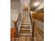 A staircase with wood stairs and black metal balusters and dark stained wood banister at 7848 Rock Rose Ln, Fairburn, GA 30213
