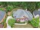 Aerial view highlighting this beautiful home's manicured lawn, elegant brickwork, and mature landscaping at 9175 Etching Overlook, Johns Creek, GA 30097
