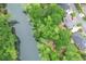 Overhead view of a home near a body of water surrounded by lush trees at 9175 Etching Overlook, Johns Creek, GA 30097