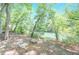 A seating area overlooks a tranquil river, providing a serene and picturesque retreat at 9175 Etching Overlook, Johns Creek, GA 30097