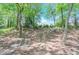 Secluded backyard with lush greenery, featuring a charming seating area for peaceful relaxation at 9175 Etching Overlook, Johns Creek, GA 30097