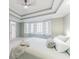 This large bedroom offers natural light, neutral carpet, and ensuite bathroom access at 9175 Etching Overlook, Johns Creek, GA 30097
