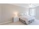 Bedroom featuring neutral decor, a comfortable bed with white linens, and a window with shutter at 9175 Etching Overlook, Johns Creek, GA 30097