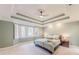 Serene bedroom with natural light, tray ceiling, and calm color palette at 9175 Etching Overlook, Johns Creek, GA 30097