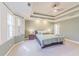 The bedroom boasts a tray ceiling, neutral carpet, and ensuite bathroom access at 9175 Etching Overlook, Johns Creek, GA 30097