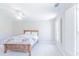 This bedroom offers neutral walls, carpeted floors, a ceiling fan, and a window with shutters at 9175 Etching Overlook, Johns Creek, GA 30097