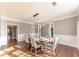 Dining room features hardwood floors, modern lighting, and a view of the home's entryway at 9175 Etching Overlook, Johns Creek, GA 30097