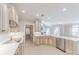 Well-lit kitchen with stainless steel appliances, custom cabinets, and ample counter space for meal preparation at 9175 Etching Overlook, Johns Creek, GA 30097