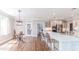Bright kitchen boasts stainless steel appliances, shaker cabinets, a center island and hardwood floors at 9175 Etching Overlook, Johns Creek, GA 30097