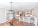 Bright kitchen boasts stainless steel appliances, shaker cabinets, a center island and hardwood floors at 9175 Etching Overlook, Johns Creek, GA 30097