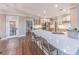 Modern kitchen with a large island, stainless steel appliances, and hardwood floors at 9175 Etching Overlook, Johns Creek, GA 30097