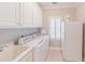 Well-equipped laundry room featuring washer and dryer for convenient chore management at 9175 Etching Overlook, Johns Creek, GA 30097