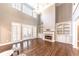 Living room features hardwood floors, fireplace, built-in bookshelves, and French doors at 9175 Etching Overlook, Johns Creek, GA 30097