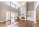 Living room boasts tall ceilings, built-in shelving, fireplace and French doors to the patio at 9175 Etching Overlook, Johns Creek, GA 30097