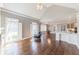 Open living area with hardwood flooring, fireplace, and access to a modern kitchen at 9175 Etching Overlook, Johns Creek, GA 30097