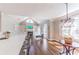 Bright living room with hardwood floors, modern lighting, and direct kitchen access at 9175 Etching Overlook, Johns Creek, GA 30097