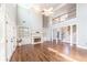 Bright living room with high ceilings, hardwood floors, built-in shelving, and a fireplace at 9175 Etching Overlook, Johns Creek, GA 30097