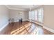 Living room with hardwood floors, lots of natural light, decorative trim, and neutral paint at 9175 Etching Overlook, Johns Creek, GA 30097