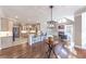 Open-concept living room and kitchen with hardwood floors and modern lighting fixtures at 9175 Etching Overlook, Johns Creek, GA 30097
