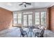 Outdoor patio with brick walls, tile floors, and multiple windows for lots of natural light at 9175 Etching Overlook, Johns Creek, GA 30097