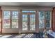 Relaxing patio with brick walls, tile flooring, and multiple windows overlooking the garden at 9175 Etching Overlook, Johns Creek, GA 30097