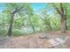 A charming seating area overlooks a tranquil river, providing a serene and picturesque retreat at 9175 Etching Overlook, Johns Creek, GA 30097