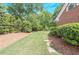 Landscaped side yard with stepping stones and lush greenery, offering a peaceful outdoor space at 9175 Etching Overlook, Johns Creek, GA 30097