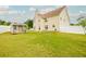 Spacious backyard featuring a large lawn, small building, and privacy fence at 13347 Henderson Ct, Hampton, GA 30228