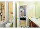 Bright bathroom with bathtub, shower, and a glimpse into the bedroom with unique window at 13347 Henderson Ct, Hampton, GA 30228