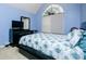 Cozy bedroom featuring a blue accent wall, large window, and modern furnishings at 13347 Henderson Ct, Hampton, GA 30228