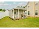 Outdoor building with porch, matching the main home's design, in a fenced yard at 13347 Henderson Ct, Hampton, GA 30228