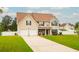 Charming two-story home featuring a two-car garage and a well-maintained lawn at 13347 Henderson Ct, Hampton, GA 30228
