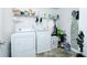 Functional laundry room with washer, dryer, shelving, and ample storage space at 13347 Henderson Ct, Hampton, GA 30228
