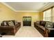 Cozy living room featuring plush sofas, decorative pillows, and a serene aquarium at 13347 Henderson Ct, Hampton, GA 30228
