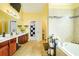 Main bath featuring double vanity, tub, and tiled floors at 13347 Henderson Ct, Hampton, GA 30228