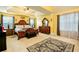 Spacious main bedroom boasts tray ceiling, rug, and natural light at 13347 Henderson Ct, Hampton, GA 30228