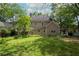 Large backyard with lush green lawn and mature trees, offering ample space for outdoor activities at 30 Sessions Nw St, Marietta, GA 30060