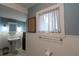 Elegant bathroom featuring white walls with wainscoting, dark wood dresser and pedestal sink at 30 Sessions Nw St, Marietta, GA 30060