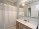 Traditional bathroom with a white shower curtain and vanity with a mirrored medicine cabinet above the sink at 30 Sessions Nw St, Marietta, GA 30060