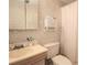 Cozy bathroom with floral wallpaper, vintage cabinets, and a shower curtain at 30 Sessions Nw St, Marietta, GA 30060