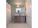 Neutral colored bathroom with a vanity sink, mirrored medicine cabinet, and a bathtub with a white shower curtain at 30 Sessions Nw St, Marietta, GA 30060