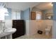 Charming bathroom with period details featuring white wainscoting, blue walls, and a pedestal sink at 30 Sessions Nw St, Marietta, GA 30060