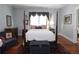 Inviting bedroom with hardwood floors, neutral paint, and decorative furniture at 30 Sessions Nw St, Marietta, GA 30060