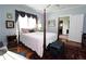 Charming bedroom with four poster bed, hardwood floors, and ample natural light at 30 Sessions Nw St, Marietta, GA 30060