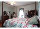 Charming bedroom featuring a four poster bed, ceiling fan, hardwood floors, and traditional decor at 30 Sessions Nw St, Marietta, GA 30060